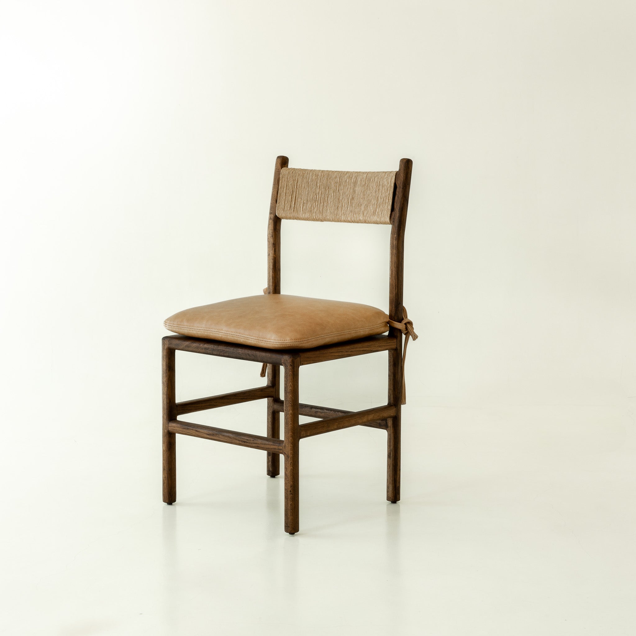 Romi solid oak dining chair in chocolate colour way with leather cushion - front angel 